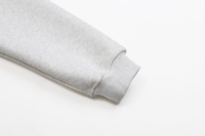 Ash grey hoodie sleeve cuff close-up with ribbed wristband