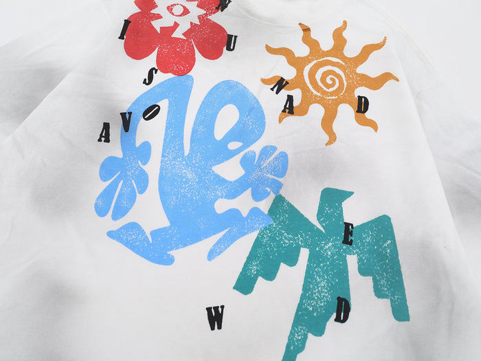 White graphic tee with colorful abstract sun and flower prints in red, blue, orange, and teal streetwear style