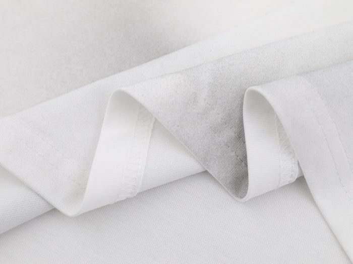 White washed cotton tee fabric with soft cloud-dye texture and visible folded seams for a streetwear look