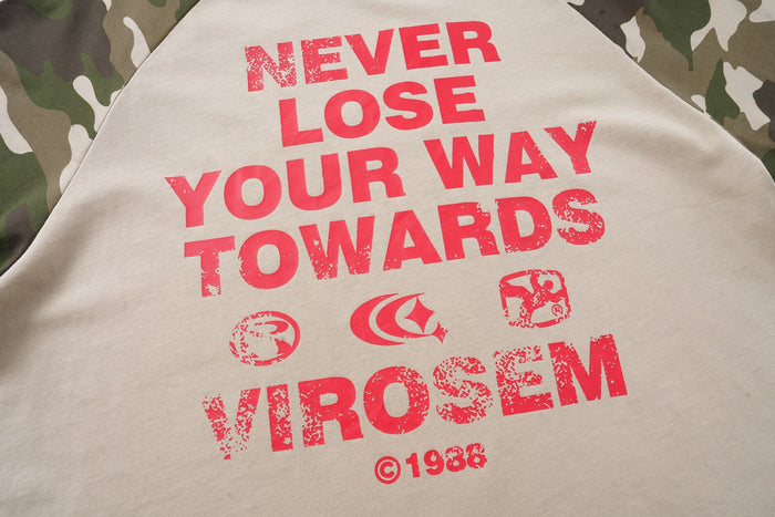 Camo raglan T-shirt with bold red Never Lose Your Way print on beige fabric, close-up streetwear graphic detail