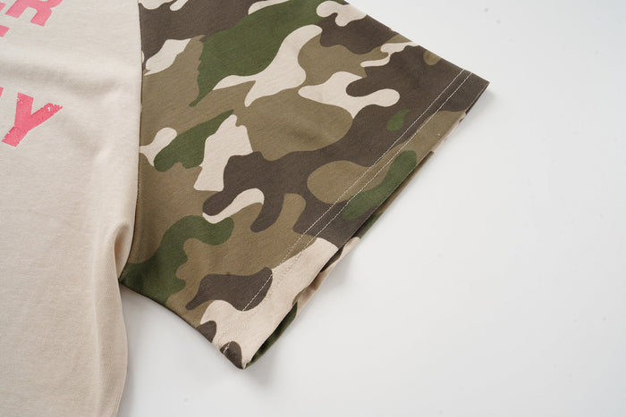 Camo raglan T-shirt sleeve detail with beige body and bold pink lettering on a streetwear top