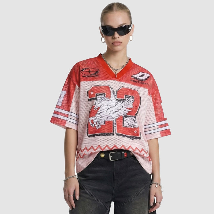 Model wearing a red and white mesh jersey T-shirt with a large number 22 and winged horse graphic, styled with black pants and sunglasses
