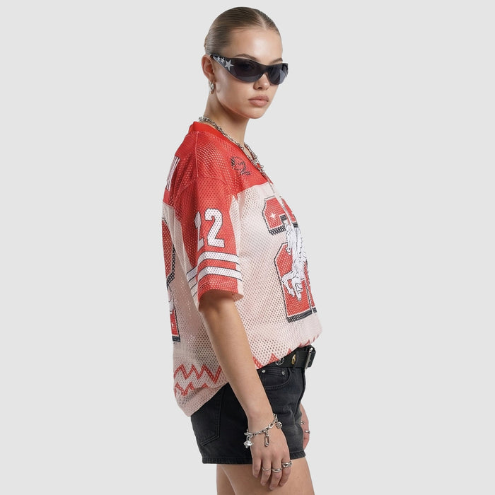 Model wearing a red and white mesh jersey T-shirt with bold 22 graphic, black shorts, and sunglasses