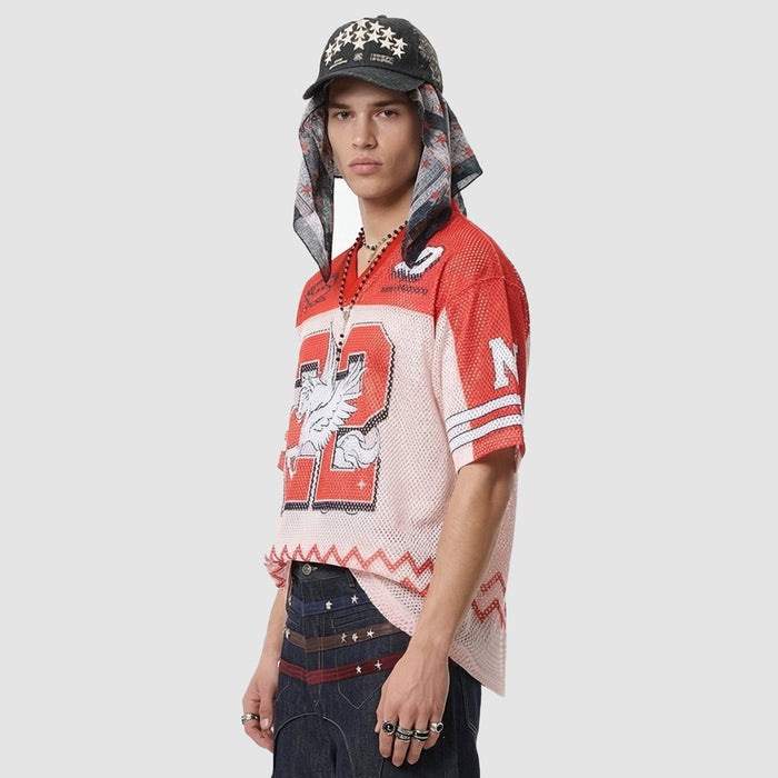 Red mesh jersey T-shirt with bold Noble Sun 22 graphics, styled on a model with cap and layered streetwear look