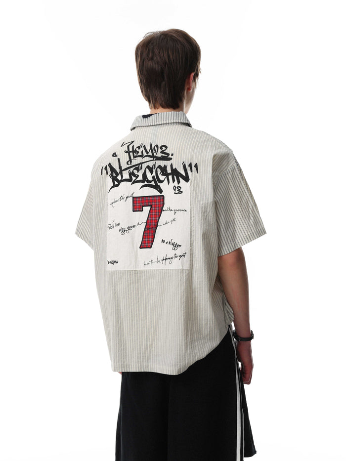 Back view of a pinstripe streetwear button-up shirt with graffiti-style graphic patch and red number 7 on the back