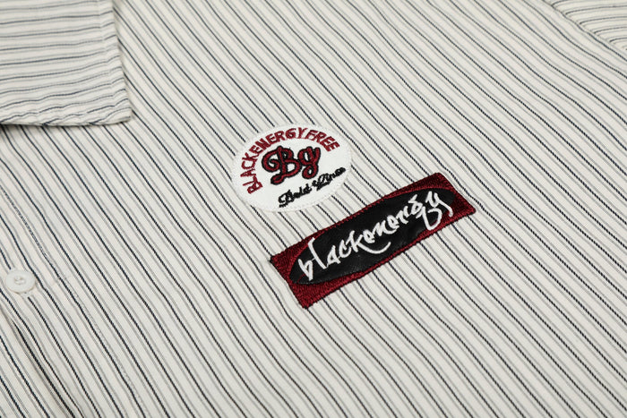 White pinstripe button-up shirt with embroidered graphic patches and black-red streetwear details