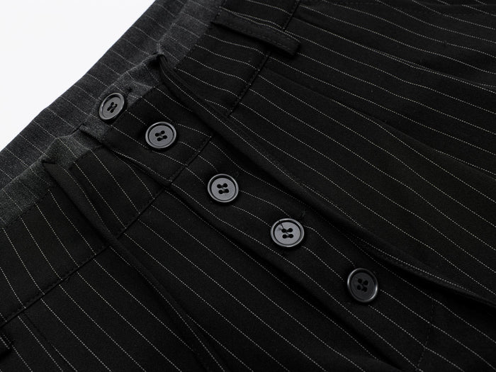 Close-up of black pinstripe shorts front buttons and waistband detail