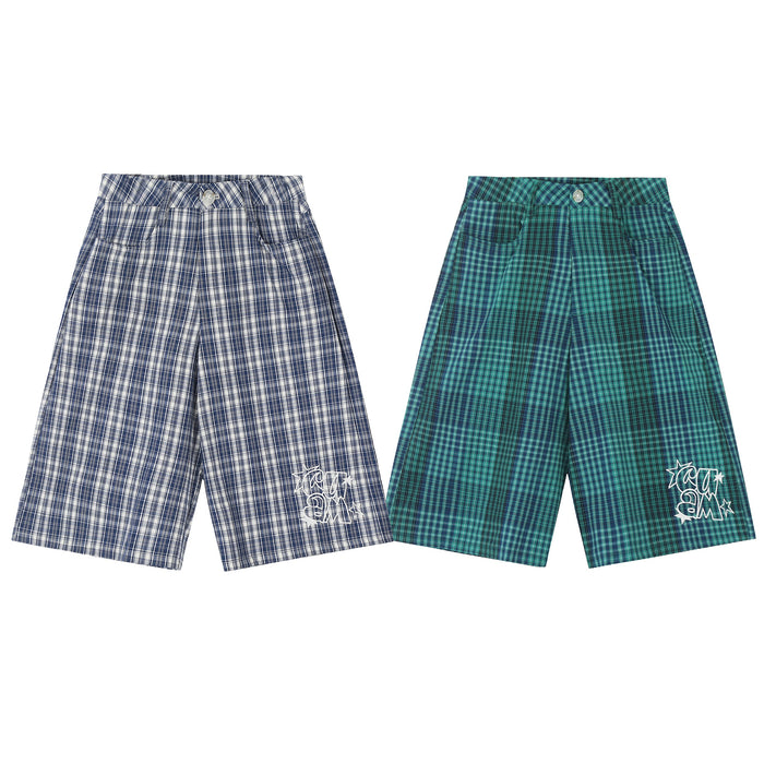 Navy and teal plaid wide-leg shorts with white embroidered logo detail, shown side by side on white background