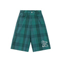 Green plaid wide-leg shorts with front pockets and white graphic at the leg