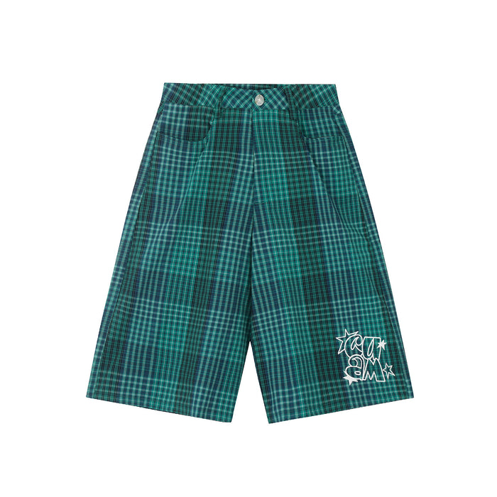 Green plaid wide-leg shorts with front pockets and white graphic at the leg