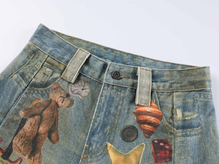 Close-up of the waistband with belt loops, button closure, and printed denim detail