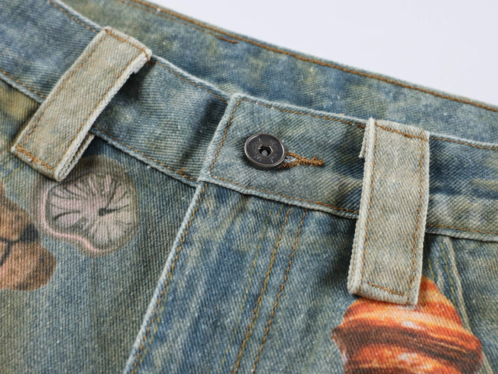 Close-up of the waistband button and belt loops on printed blue denim