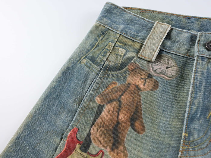 Front upper section of printed wide leg denim jeans with teddy bear graphic