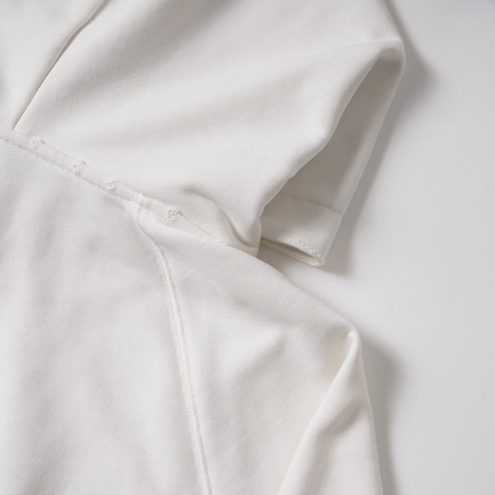 Close-up of white hoodie sleeve seam and stitching detail