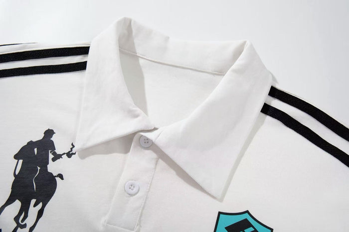 White polo shirt with black shoulder stripes, racing crest graphic, and equestrian rider silhouette on the chest