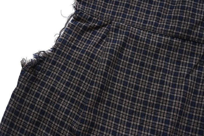 Close-up of side seam and raw-edge armhole on dark plaid shirt