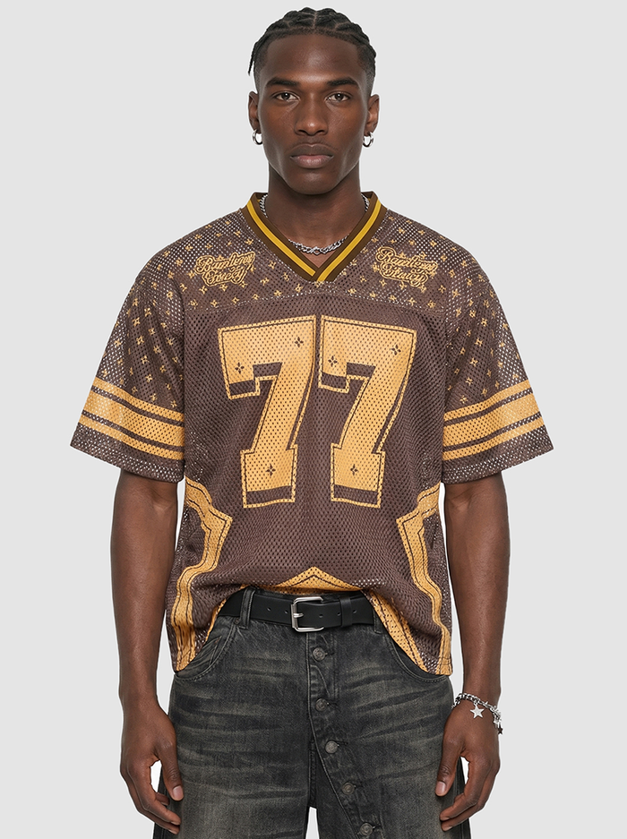 Brown mesh jersey T-shirt with gold star detailing and large 77 graphic, styled with a V-neck and striped sleeves