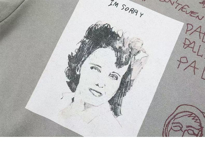 Front graphic close-up showing a portrait print with the words Im sorry on light gray sweatshirt