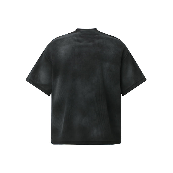 Black oversized washed tee with textured finish shown from the back on a white background