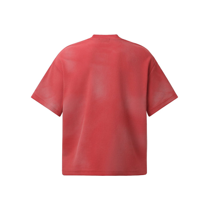 Red oversized washed tee with textured fabric and short sleeves shown from the back on a white background