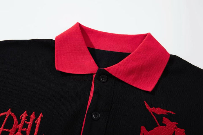Black oversized polo tee with bright red collar, button placket, and gothic red graphic embroidery on the chest