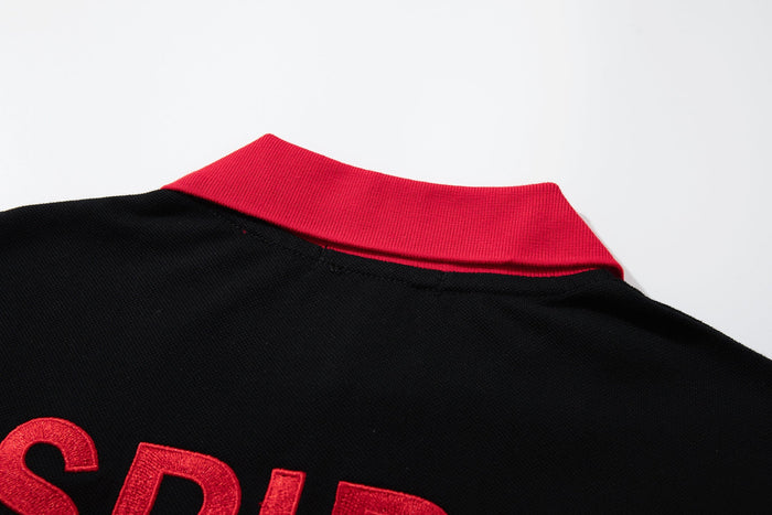 Black gothic polo tee with bold red collar and embroidered lettering, showcasing an oversized Y2K streetwear style