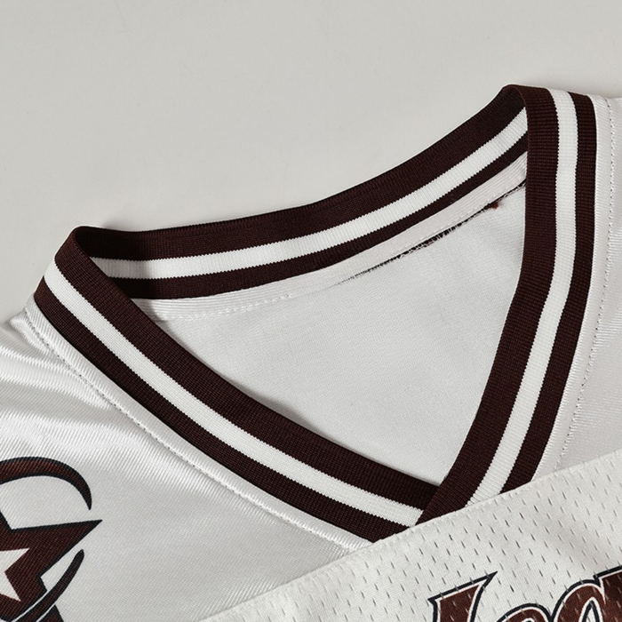 White Seakoff varsity jersey with brown striped ribbed collar and mesh athletic fabric close-up