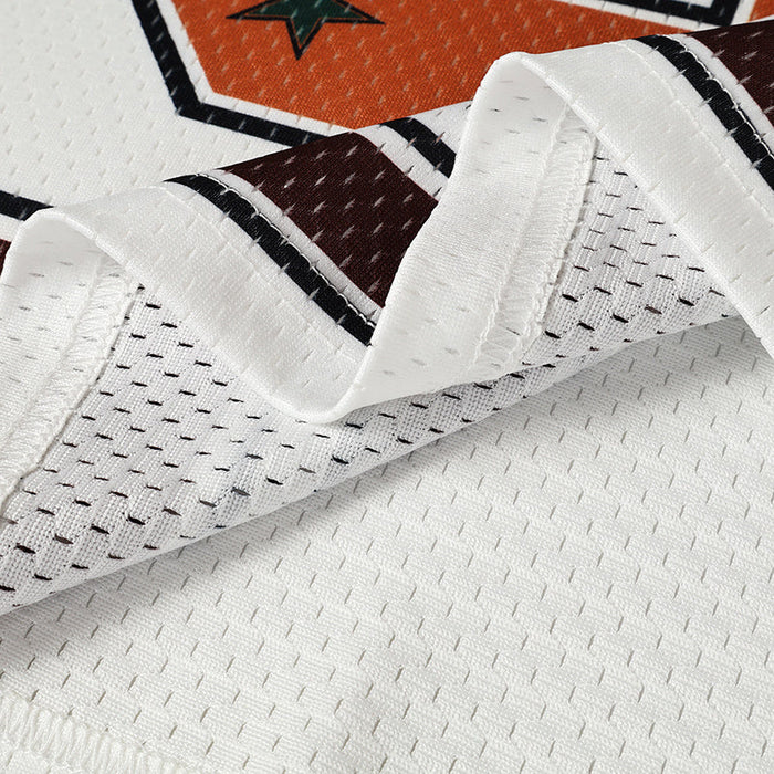 Close-up of a white mesh varsity jersey with burgundy and black star graphic detailing