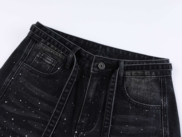 Black denim waistband and front pocket close-up with rhinestones and belt loop