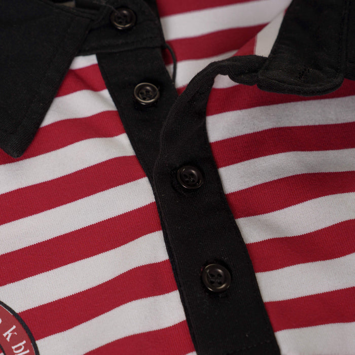 Close-up of a red and white striped polo tee with black button placket and collar detailing