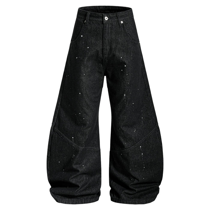 Black wide-leg jeans with white paint splatter, front view