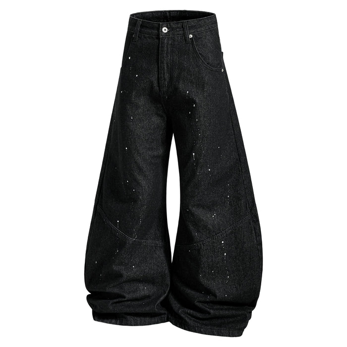 Black wide-leg jeans with paint splatter and curved side seams, front view
