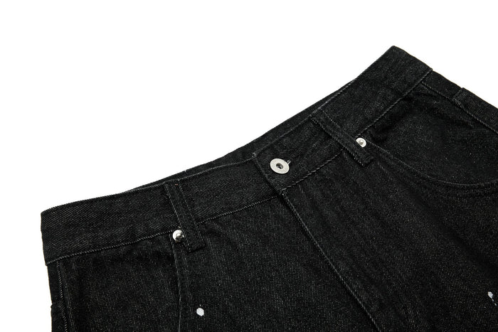 Close-up of black jeans waistband with button closure and belt loops