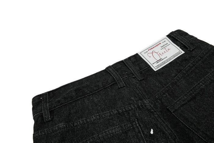 Close-up of back waistband label on black jeans