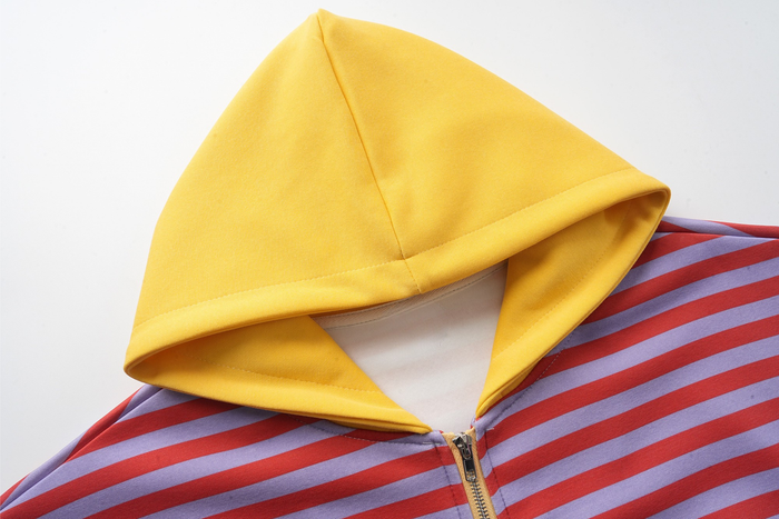 Close-up of yellow hood and top zipper on striped zip-up hoodie
