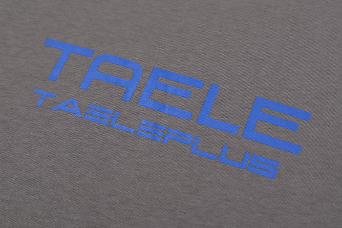 Gray streetwear T-shirt with bold blue TAELEPLUS logo print across the chest