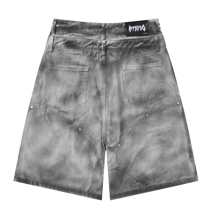 Gray denim jorts front view with studded curved seam details and back pockets