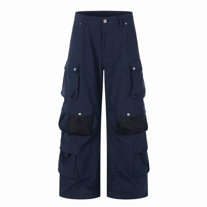 Front view of navy wide-leg cargo pants with multiple flap pockets and mesh panels