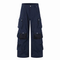 Front view of navy wide-leg cargo pants with multiple flap pockets and mesh panels