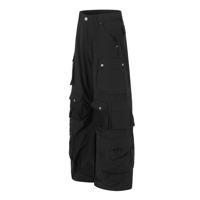 Angled front view of black wide-leg cargo pants with layered cargo pockets