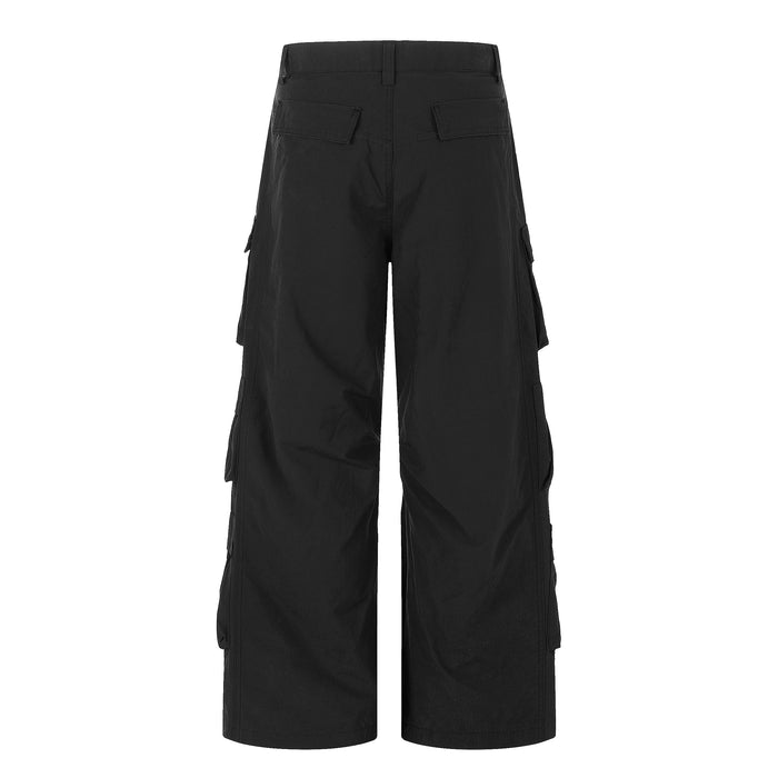 Back view of black wide-leg cargo pants with flap back pockets and wide leg shape