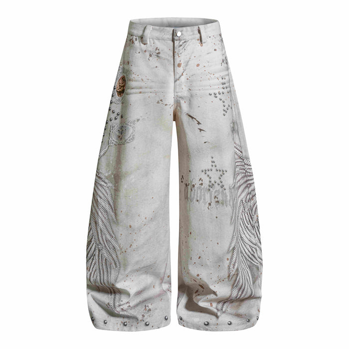 Front view of cream wide-leg jeans with angel wing prints, studded stars, and splatter wash