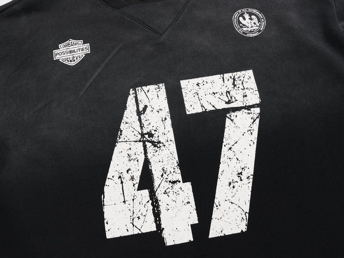 Close-up of black jersey front showing distressed 47 print and small chest emblems