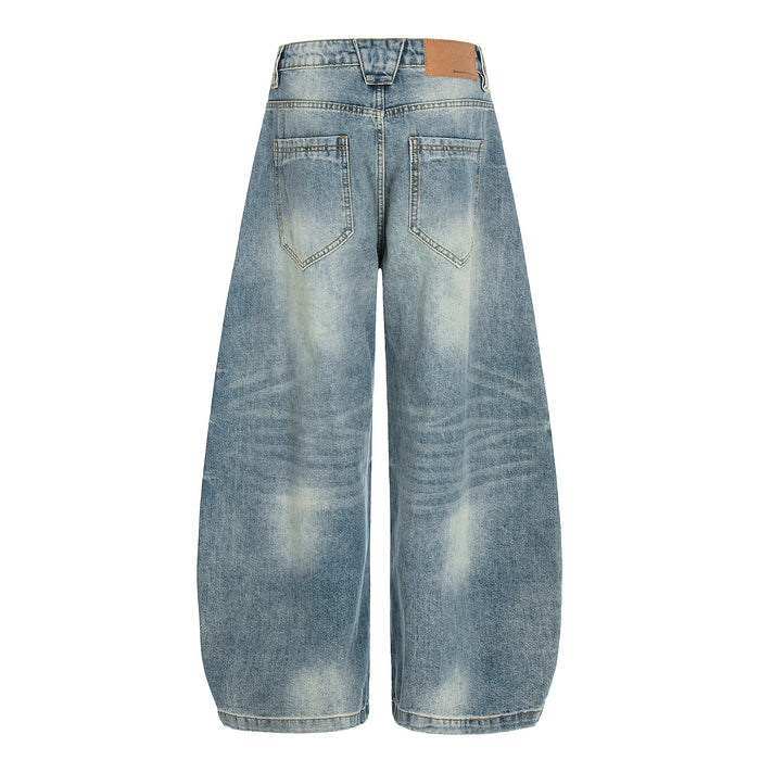 Back view of light wash wide-leg jeans with patch pockets and tan waistband label