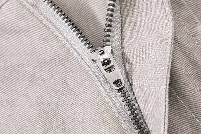 Close-up of light beige denim zipper and inner waistband seam