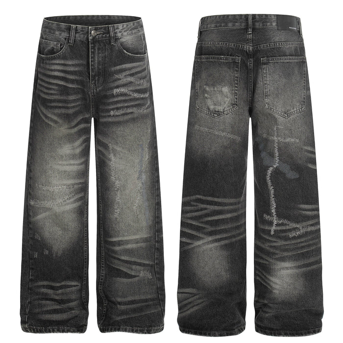 Front and back view of grey washed distressed wide-leg denim jeans with fading and abrasion detailing