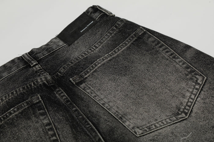 Close-up of back waistband and rear pocket on washed black wide-leg jeans