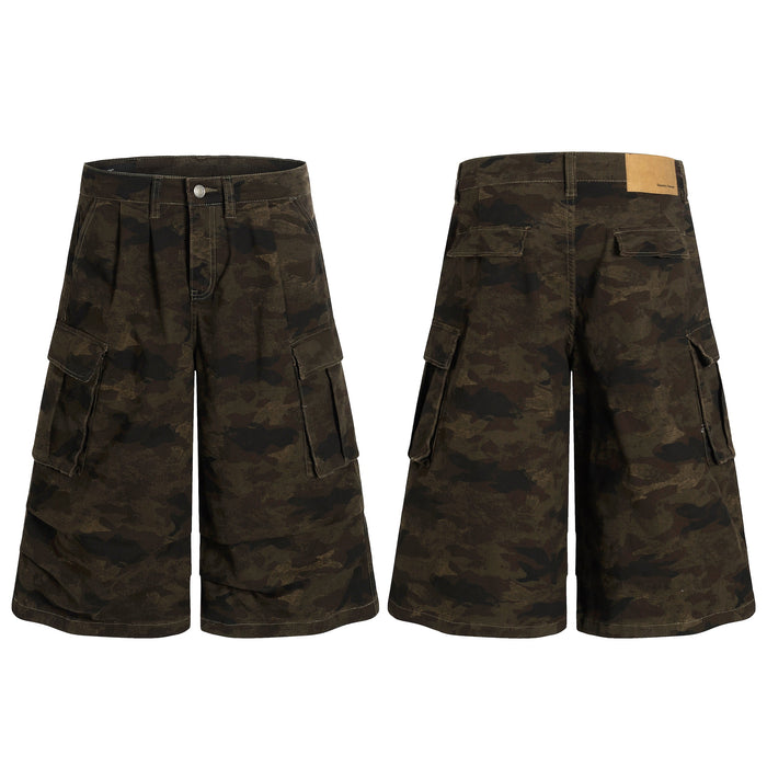 Front and back view of wide-leg dark olive camo cargo shorts with oversized flap pockets and deep front pleats