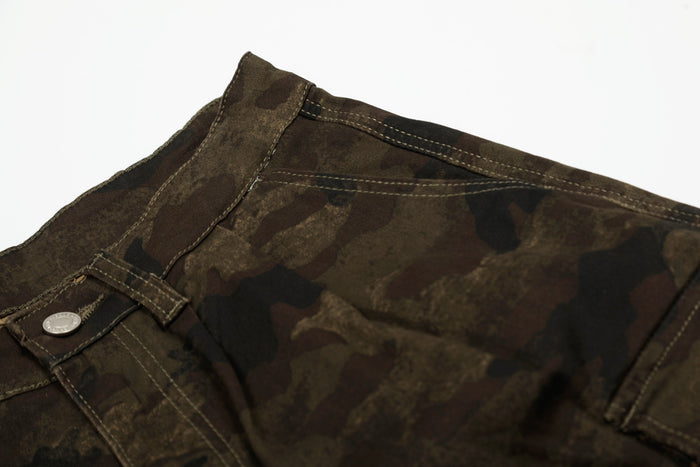 Close-up of camo shorts waistband with button closure and top stitching