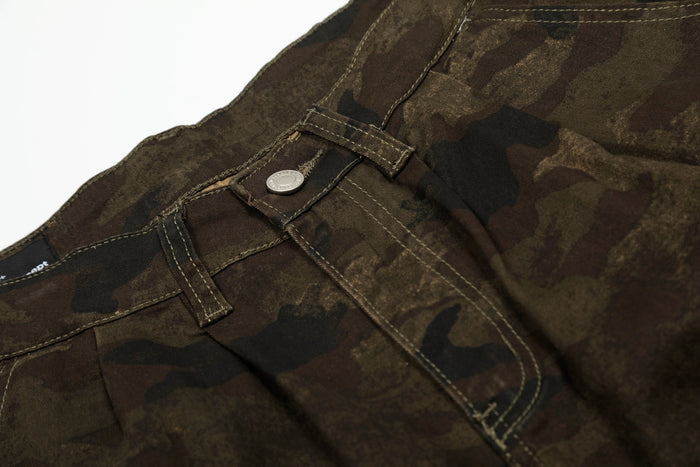 Close-up of front pocket area on camo cargo shorts with stitched seam details